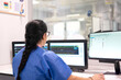 © Carmen - Medical professional monitoring patient vitals on multiple computer screens