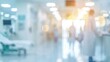 © Eireen - Medical concept background with blurred silhouette of doctor walking in bright hospital corridor with bokeh light effect