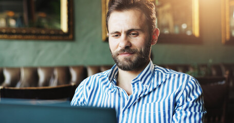 Aufkleber - Laptop, small business and typing with man in coffee shop for blogging, planning or research online. Computer, internet and startup with freelance employee in cafe or restaurant for remote work