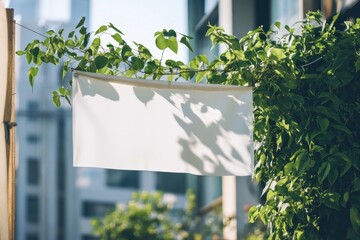 Aufkleber - Blank canvas banner amidst lush greenery, casting shadows for an organic and tranquil feel. Ideal for displays or signage.
