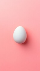Poster - White egg is placed on a pink backdrop, creating a simple yet visually appealing composition, ideal for food related projects or minimalist designs, evoking feelings of freshness and simplicity