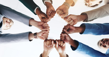 Poster - Hands, business people and fist bump for teamwork, solidarity or cooperation below. Circle, collaboration and community of employees huddle for motivation, mission or support in office with low angle