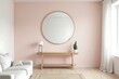 © ovik - Contemporary Living Room Featuring Round Mirror and Light Wood Console Table on a Blush Pink Wall.