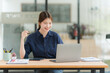 © Kritdanai - Young Woman Working at Desk with Laptop