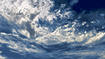 Fototapete - Dramatic blue sky with swirling white clouds, creating a textured, dynamic appearance symbolizing movement, energy, and vastness, ideal for nature or weather concepts