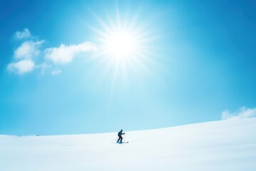 skier enjoying clear blue sky and bright sunshine on slope