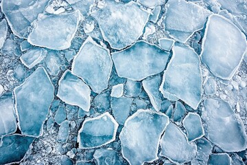 Poster - A stunning aerial view of fragmented ice floes, exhibiting a captivating texture and icy blue hues.