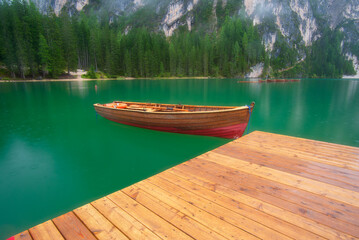 Wall Mural - boat on lake braies, dolomites, italy. lake and reflections on the water surface. mountain landscape