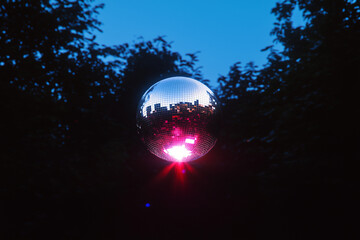 Poster - Mystical Orb: A captivating, polished orb glows amidst a twilight scene, reflecting a vibrant urban landscape, offering a unique perspective on the fusion of nature and city life.