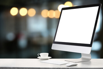 Aufkleber - Computer monitor with blank screen and cup on marble desk against blurred background. Mockup for design