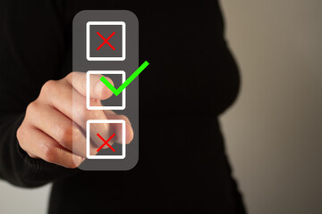 Poster - a woman points to a green check mark as other options are discarded. this indicates approval or agre
