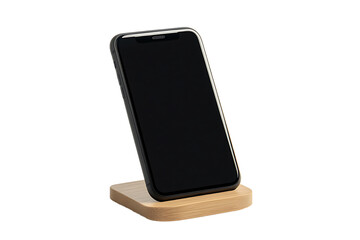 Aufkleber - Black smartphone resting on a light wood stand against a plain black background in studio setting