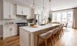 © oni - Modern white kitchen with an island and large windows overlooking a backyard