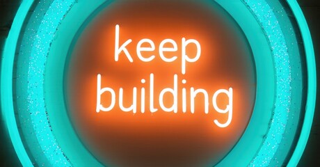 Fototapete - Bright neon sign displays positive message. Orange text on red background, surrounded by teal rings. Inspiring, motivational design.