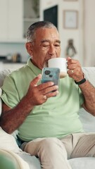 Poster - Senior man, phone and coffee on sofa with texting, scroll and contact with web chat in living room. Elderly person, smartphone and mug with tea, latte and mobile app for social media in retirement