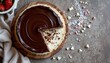 © Thi - Minimalist top down photo of chocolate ganache cake, placed on the left side over soft dessert board