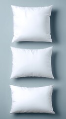 Poster - Minimalist Composition of Three White Pillows Arranged Vertically on a Soft Blue Background in a Clean Modern Style for Home Decor and Comfort