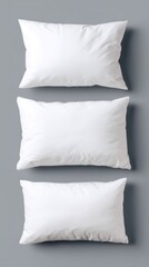 Poster - Minimalist arrangement of three white pillows on a gray background soft bedding concept clean and simple bedroom decor comfortable sleep neutral tone studio shot.