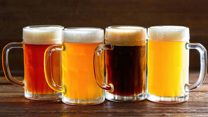 Poster - Four beers in glasses on a wooden table.