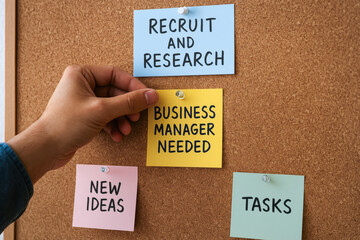 Poster - a hand placing a note labeled 'business manager needed' among various colorful reminders about recru