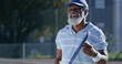 © Mitchell/peopleimages.com - Tennis, serve and smile with senior black man on court for sports tournament, competition and game. Training, exercise and championship with elderly person in outdoors for athlete, fitness and event