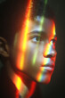 © OBSIMAGES AI  - Portrait of teenage boy under rainbow light prism,
