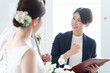 © polkadot - 新郎新婦と話す結婚式場スタッフ