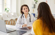 © Studio Romantic - Female young woman patient visiting friendly doctor sitting at the desk in office on her workplace and having consultation during medical examination in clinic. Medicine and health care concept.