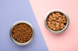 © Mouse family - Wet and dry food for dogs and cats in silver bowl on pink background.