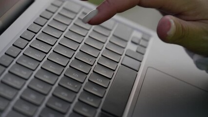 Poster - This closeup, beautifully portraying a wellmanicured hand typing on an elegant, sleek laptop, effectively blends modern technology with personal style, ultimately enhancing workplace productivity