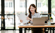 © Daenin - Young Asian woman doing financial accounting and taxes for a company Organizing account analysis reports Investment information Financial and tax system concepts