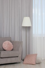 Aufkleber - Stylish room interior with comfortable armchair and beautiful window curtains