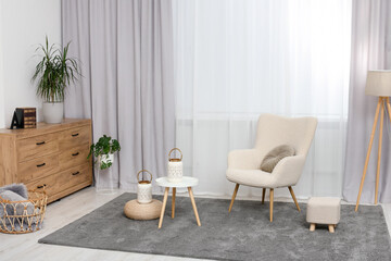 Aufkleber - Comfortable armchair, white table and stylish lanterns near elegant curtains in light room. Interior design