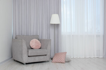 Aufkleber - Stylish room interior with comfortable armchair and beautiful window curtains