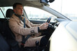 © New Africa - Driver behind steering wheel of modern car