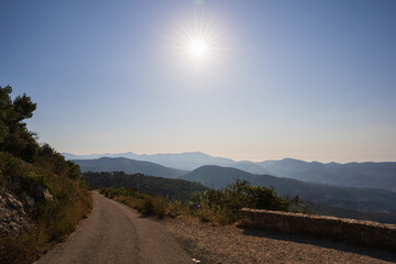 picturesque mountain landscape near nice, france, with a winding road under bright sunlight and clea