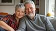 © OLHA - A man and woman sitting on a couch smiling at the camera