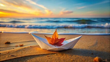 Aufkleber - A solitary paper boat, carrying an autumn leaf, rests gently on the golden sands of a tranquil beach at sunrise. The ocean waves softly caress the shore, creating a serene and peaceful atmosphere.