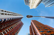 © AaronPlayStation - Low angle view of a street lamp standing among high-rise residential towers with crowded compact apartments in a community near Central District in Hong Kong, a phenomenon of severe housing shortage