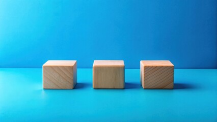 Poster - Three light wooden blocks arranged in a row on a vibrant blue surface.  A minimalist display showcasing simple geometric shapes against a bold backdrop.