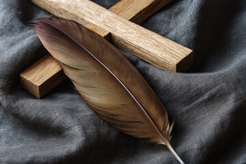 Poster - A dove feather rests on dark velvet by a wooden cross, illuminated by natural light