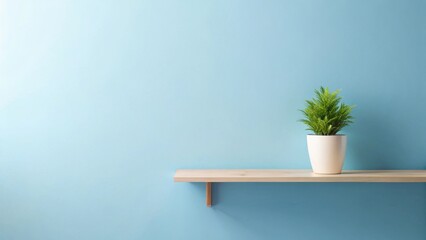 Aufkleber - A Light Blue Wall with a Simple Wooden Shelf Featuring a Potted Plant