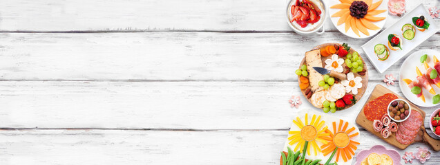 Aufkleber - Summer garden party food side border. Variety of fun flower theme charcuterie items, cheese, fruit, vegetables and finger snacks. Top view on a white wood banner background.