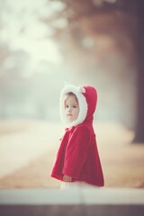 Poster - child in costume stands quietly against blurred background