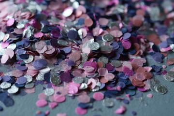 Poster - Close-up of colorful confetti texture, various shades of pink, purple, and silver glitter, creating a festive and celebratory appearance, ideal for party or celebratory designs