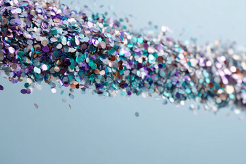 Poster - Flowing stream of iridescent glitter confetti, blue, purple, and bronze tones, on light-blue background, creating festive, celebratory mood, ideal for invitation or party design