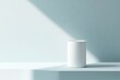 © Sadika Islam - Minimalist cylinder podium against a light blue wall