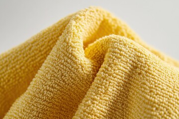 Poster - Close-up of a soft, textured yellow fabric, creating a warm and inviting atmosphere.