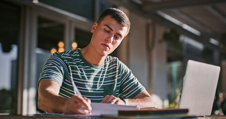 Aufkleber - Man, university student and outdoor with laptop or writing on notebook for assignment on campus. Male person, college learner and textbook for education with research or study for exam and assessment