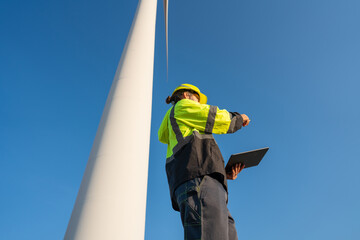 Wall Mural - engineer wearing uniform inspection and survey work in wind turbine farms rotation to generate elect